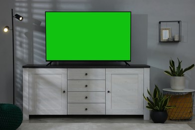 Image of Chroma key compositing. TV with mockup green screen in room. Mockup for design