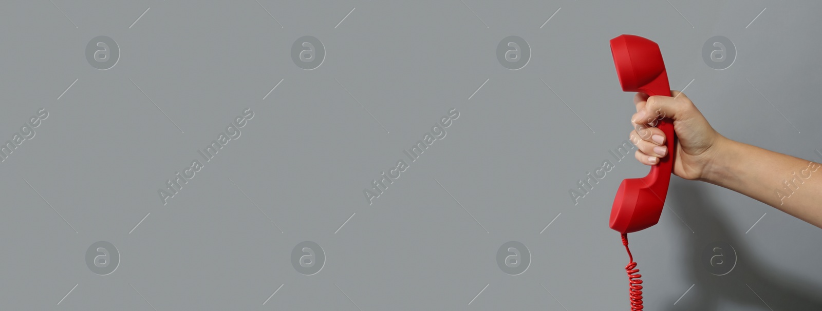 Image of Hotline service. Woman with telephone receiver and space for text on grey background, banner design