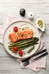 Photo of Tasty grilled salmon with tomatoes, asparagus and spices served on table, flat lay