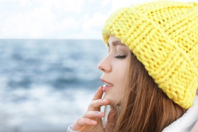 Photo of Portrait of beautiful young woman near sea, closeup. Space for text