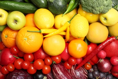 Photo of Rainbow collection of ripe fruits and vegetables as background, top view