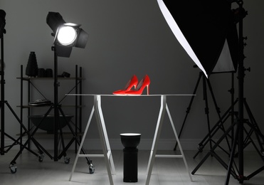 Photo of Professional photography equipment prepared for shooting stylish shoes in studio