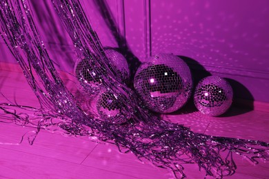 Photo of Shiny disco balls indoors, toned in purple