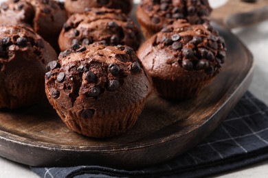 Photo of Tasty chocolate muffins on grey table, closeup