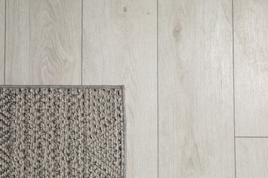 Photo of Soft grey carpet on white laminated floor indoors, top view. Space for text