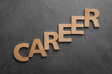 Word CAREER made with wooden letters on grey background, flat lay