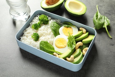 Photo of Container with natural healthy lunch on table. High protein food