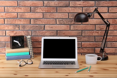 Photo of Laptop on table in home office. Mockup with space for text