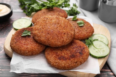 Photo of Tasty vegan cutlets served on wooden table, closeup