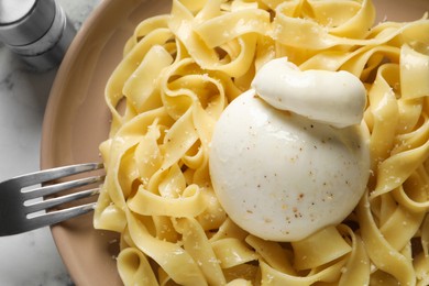Photo of Delicious pasta with burrata cheese on white table, top view