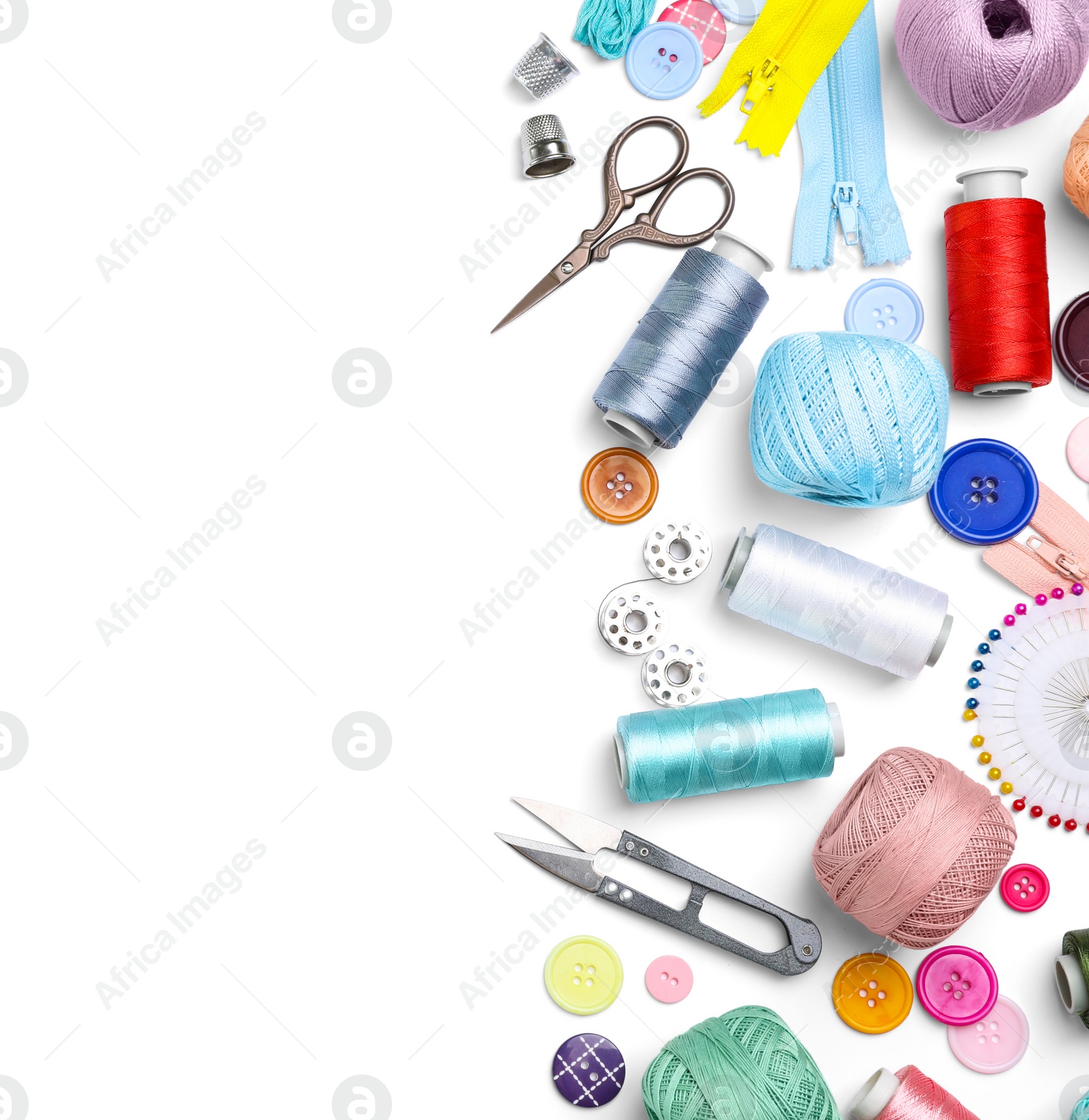 Photo of Composition with color threads and sewing accessories on white background, top view