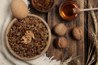 Photo of Traditional Christmas slavic dish kutia served on wooden table, flat lay