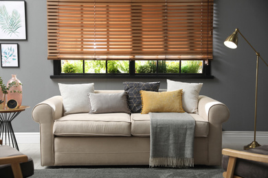 Photo of Stylish living room interior with comfortable sofa near window