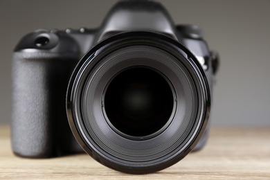 Digital camera of professional photographer on table