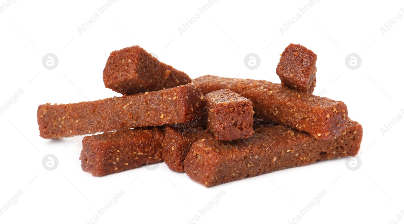 Photo of Pile of delicious crispy rusks on white background