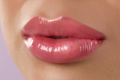 Woman with beautiful perfect lips after permanent makeup procedure, closeup