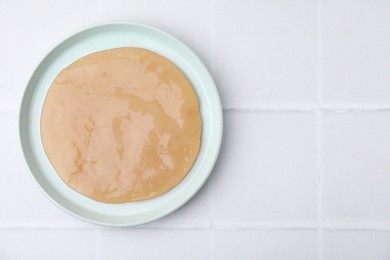 Making kombucha. Scoby fungus on white tiled table, top view. Space for text