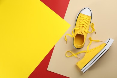 Photo of Stylish sneakers on color background, flat lay. Space for text