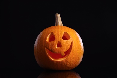 Photo of Pumpkin head on black background. Jack lantern - traditional Halloween decor