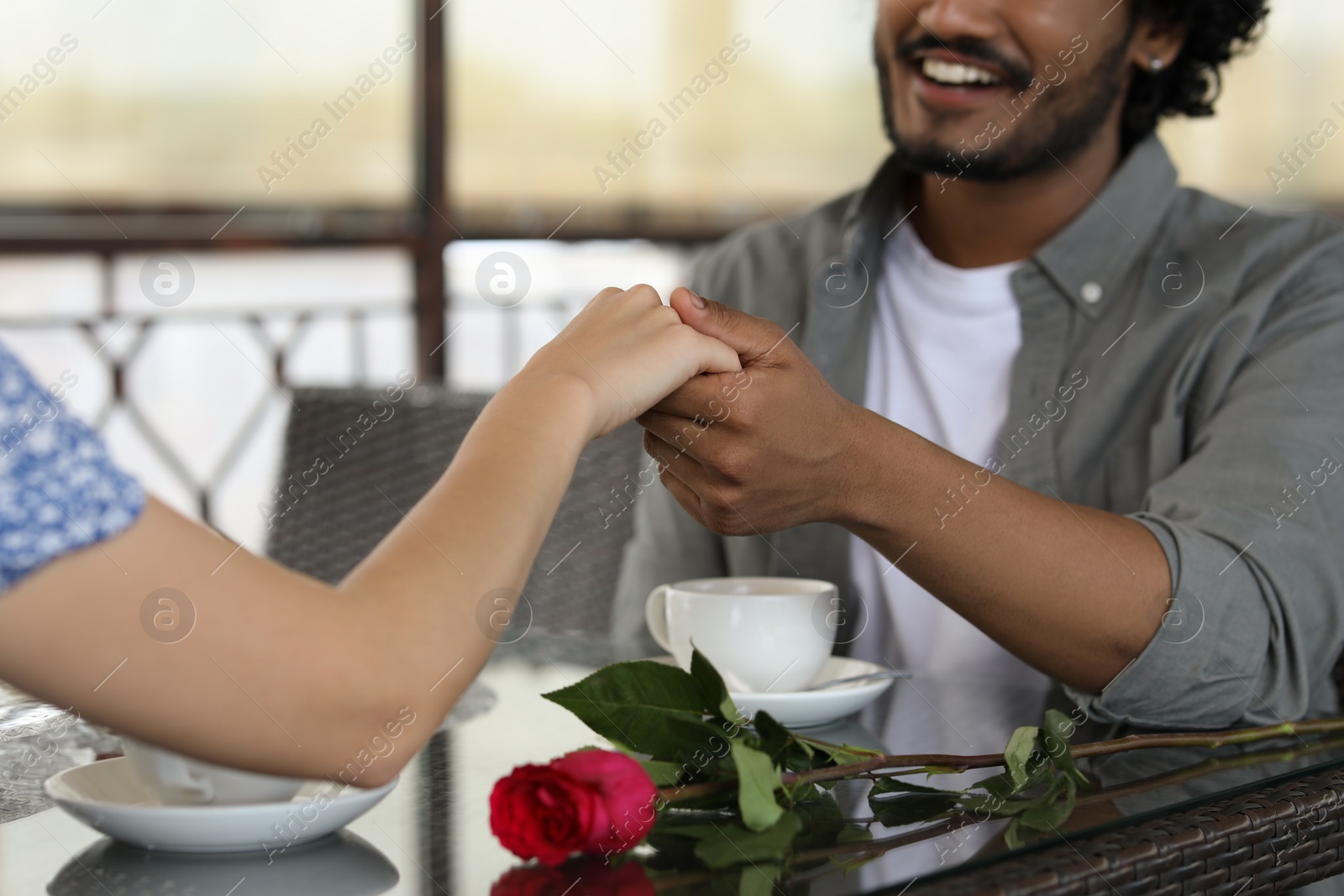 Photo of International dating. Lovely couple spending time together in restaurant, closeup