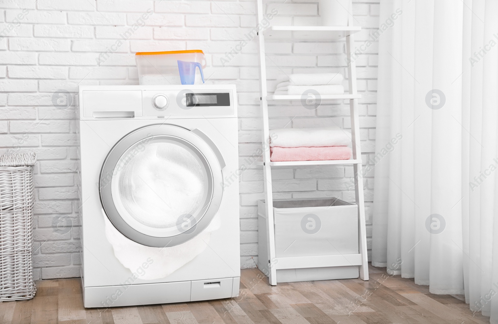 Image of Foam coming out from broken washing machine during laundering in room