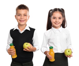 Happy children with bottles of juice and apples on white background. Healthy food for school lunch