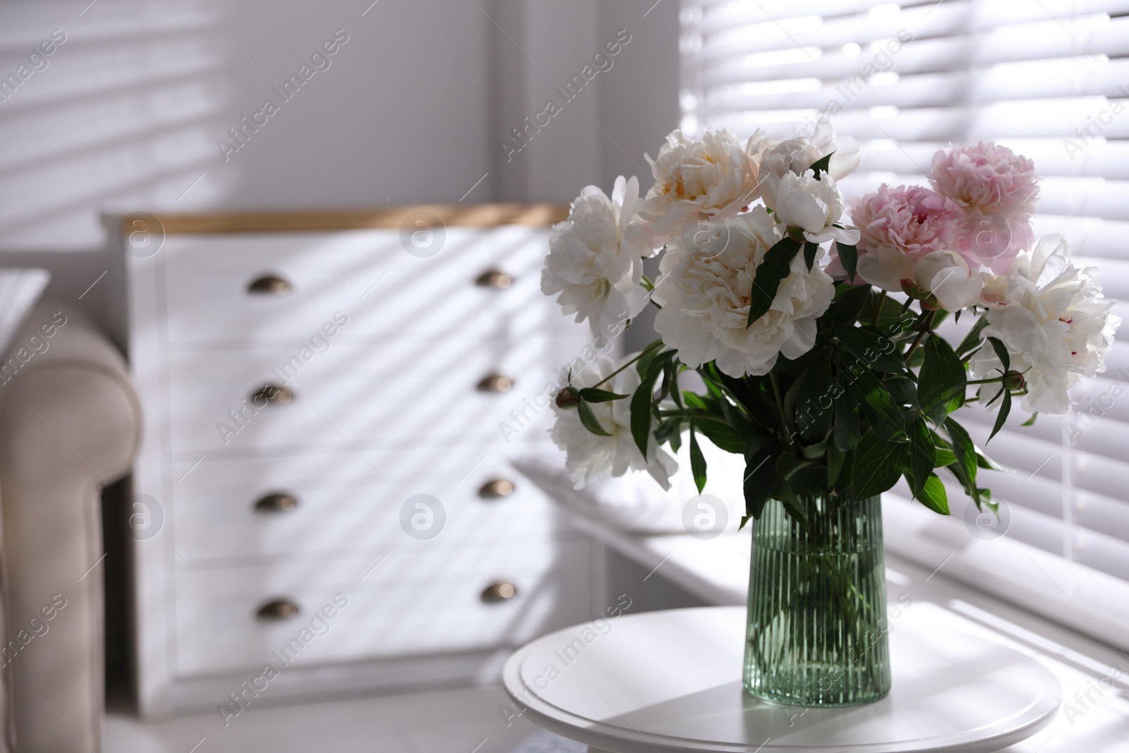 Photo of Bouquet of beautiful peony flowers on table indoors. Space for text