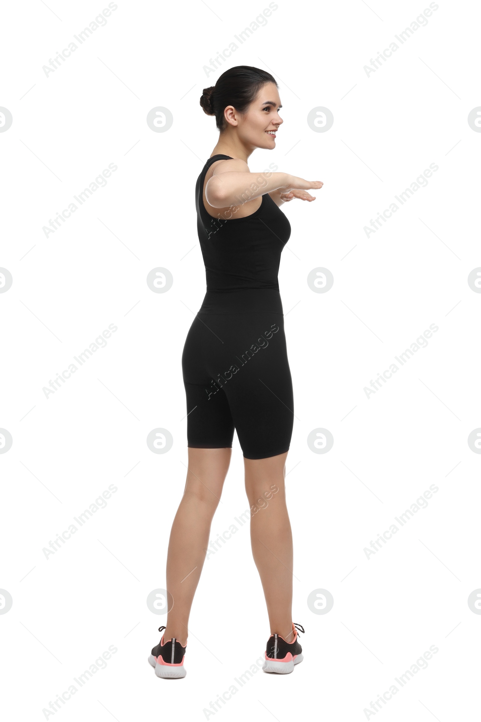Photo of Happy woman doing morning exercise on white background