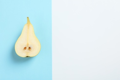 Ripe juicy pear on color background, top view