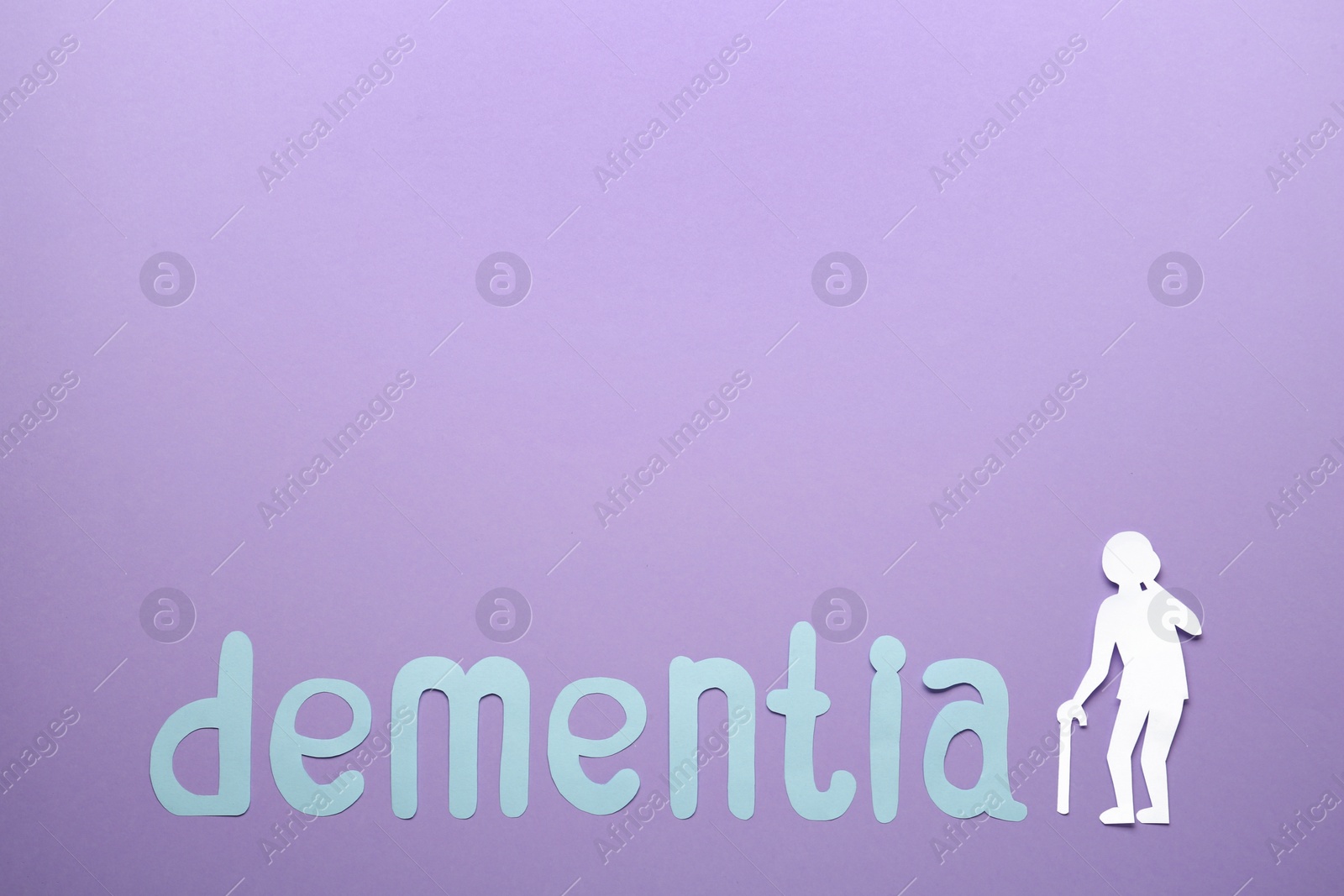 Photo of Word Dementia and old person paper cutout on violet background, flat lay. Space for text