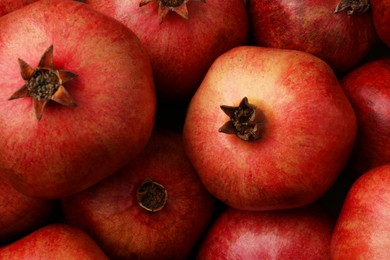 Photo of Fresh ripe pomegranates as background, top view