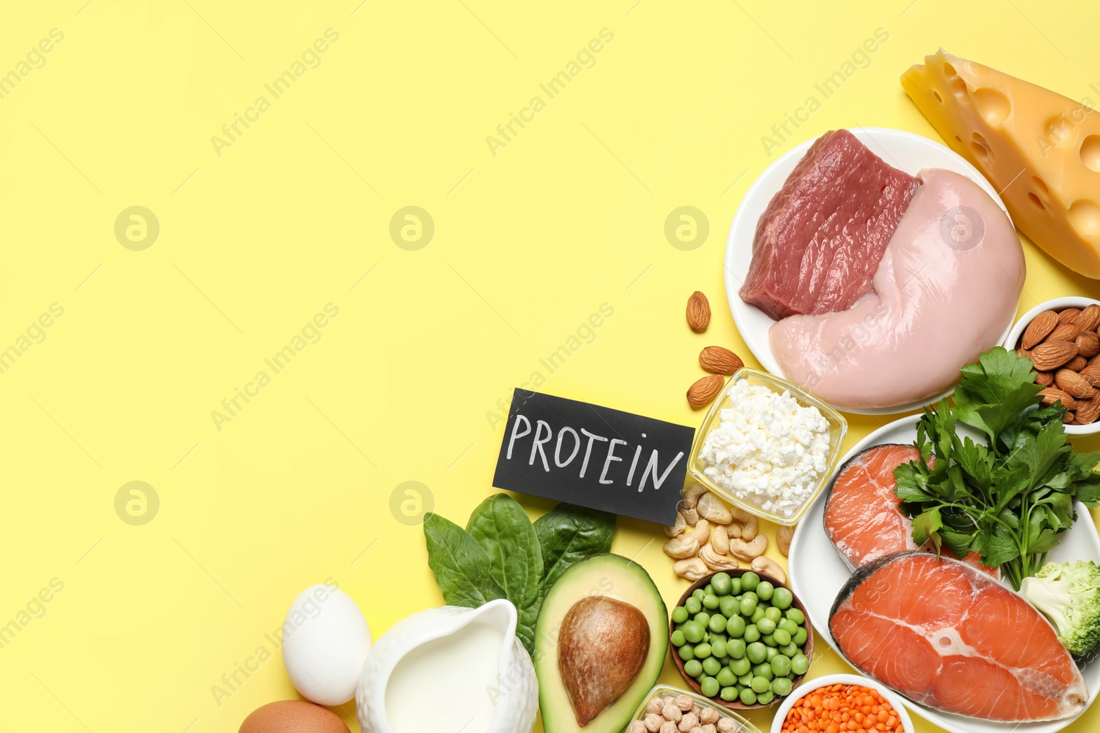 Photo of Card with word PROTEIN and different products on yellow background, flat lay. Space for text