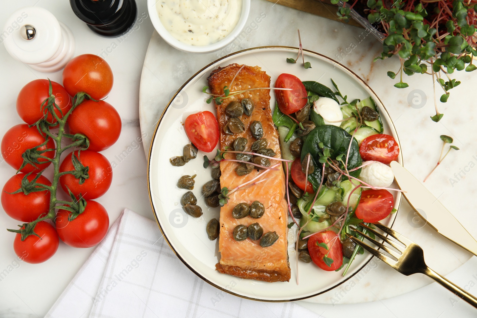 Photo of Delicious salmon with salad and capers on white marble table, flat lay.