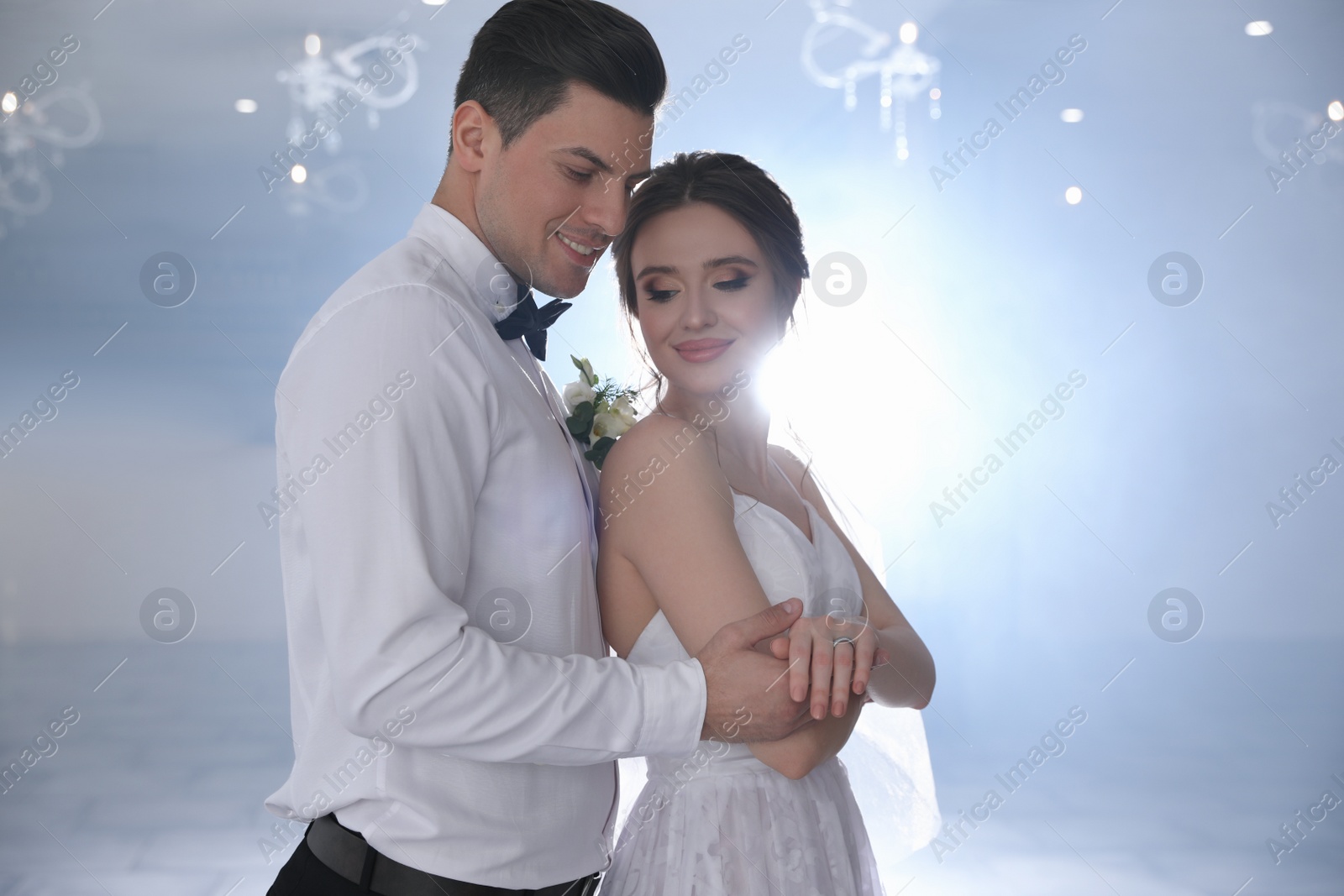 Photo of Happy newlywed couple dancing together in festive hall