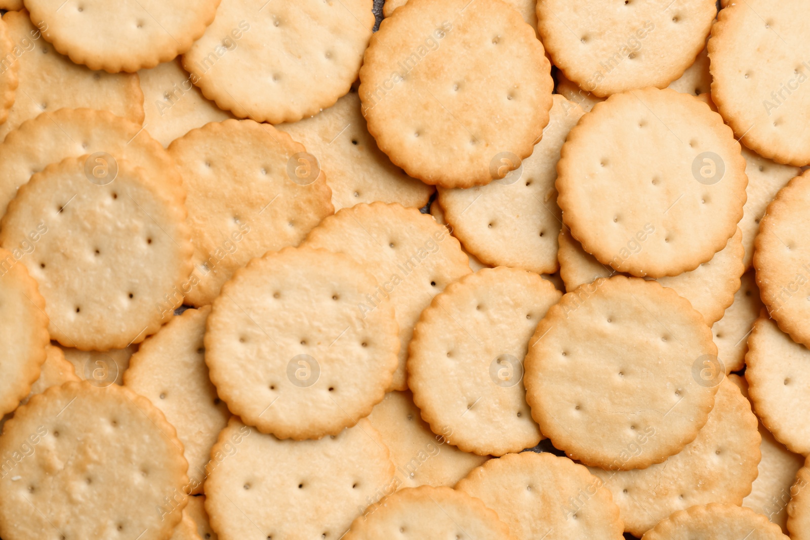 Photo of Many delicious crackers as background, top view