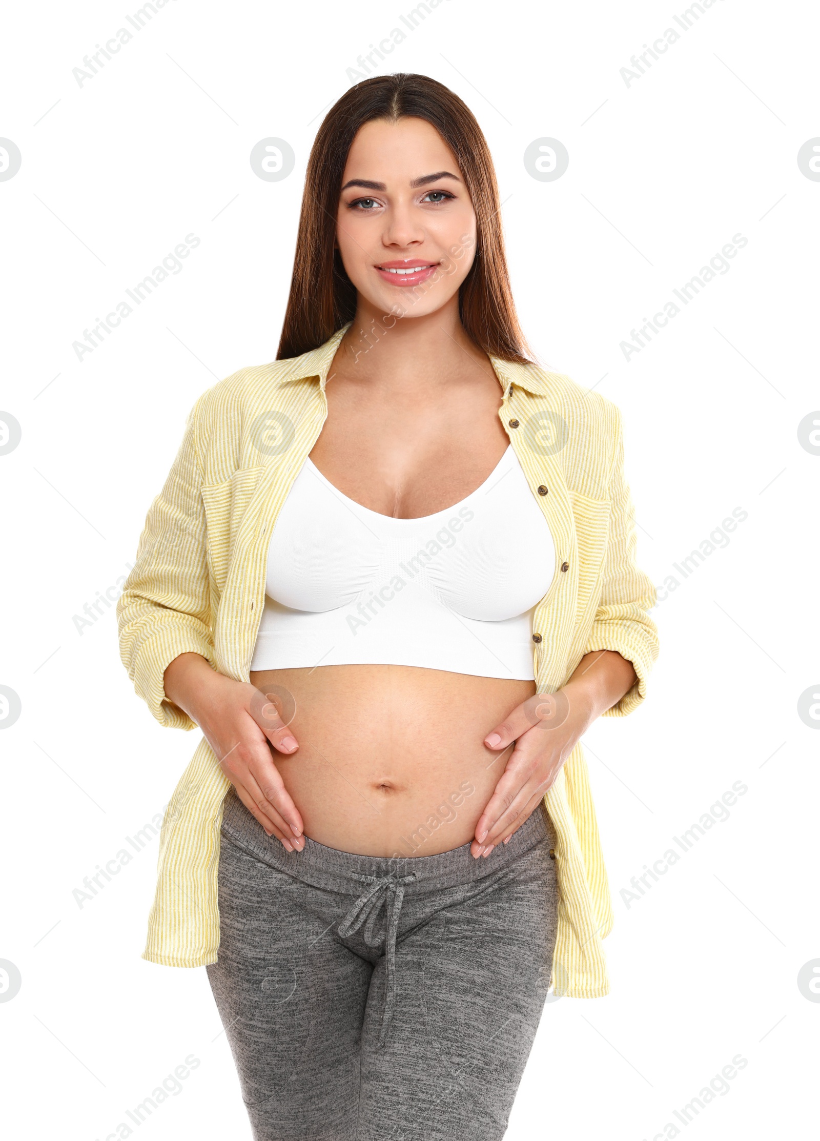 Photo of Portrait of beautiful young pregnant woman in shirt on white background