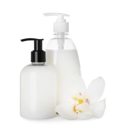 Dispensers of liquid soap and orchid flower on white background