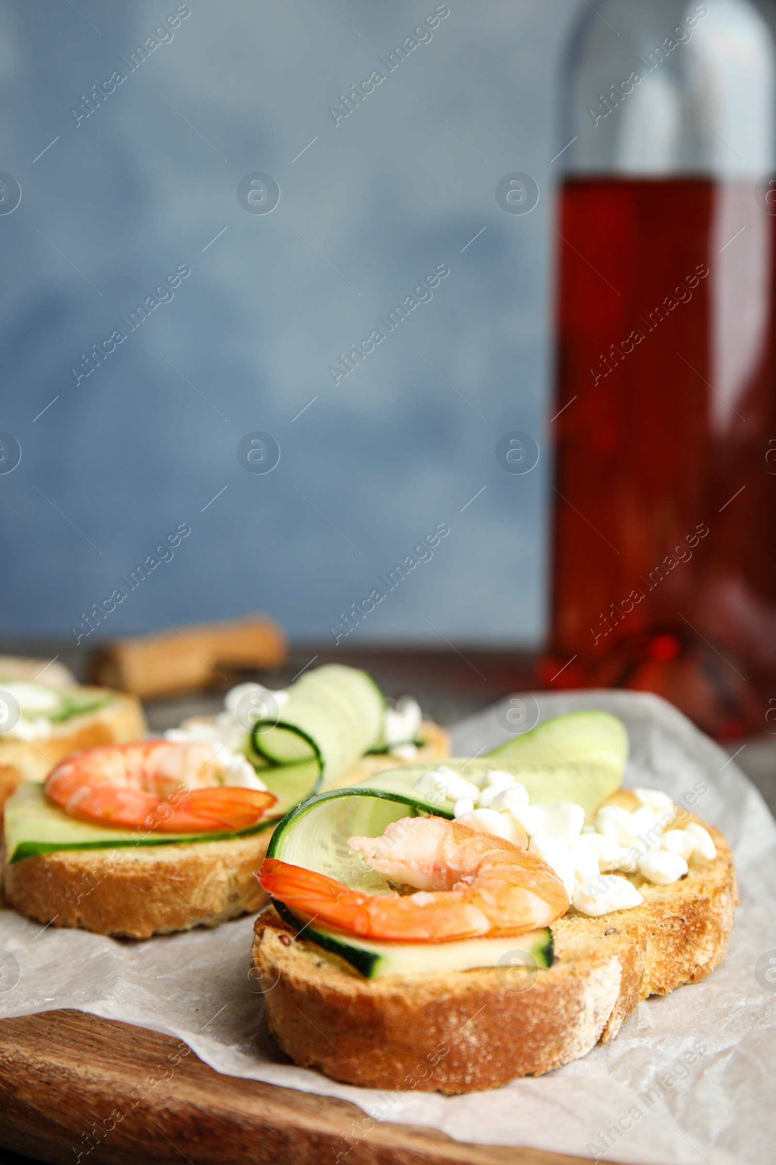 Photo of Cutting board of delicious bruschettas with shrimps, space for text