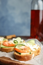 Photo of Cutting board of delicious bruschettas with shrimps, space for text