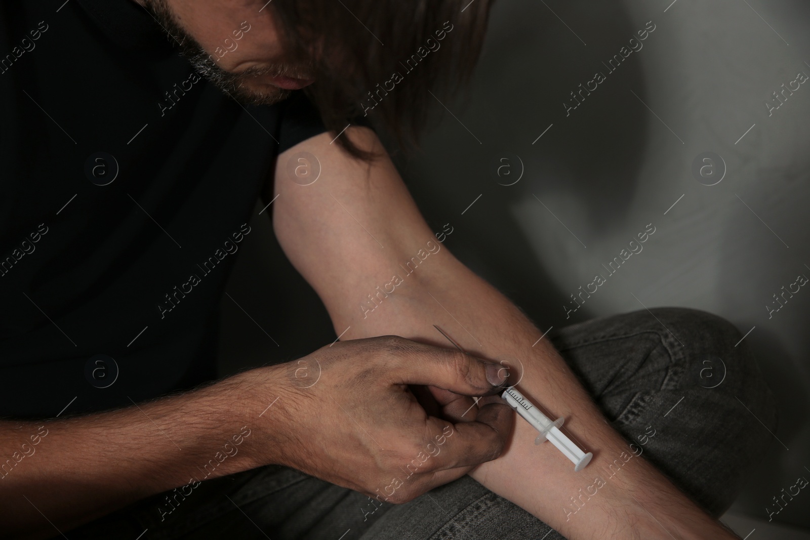 Photo of Male drug addict making injection, closeup of hands