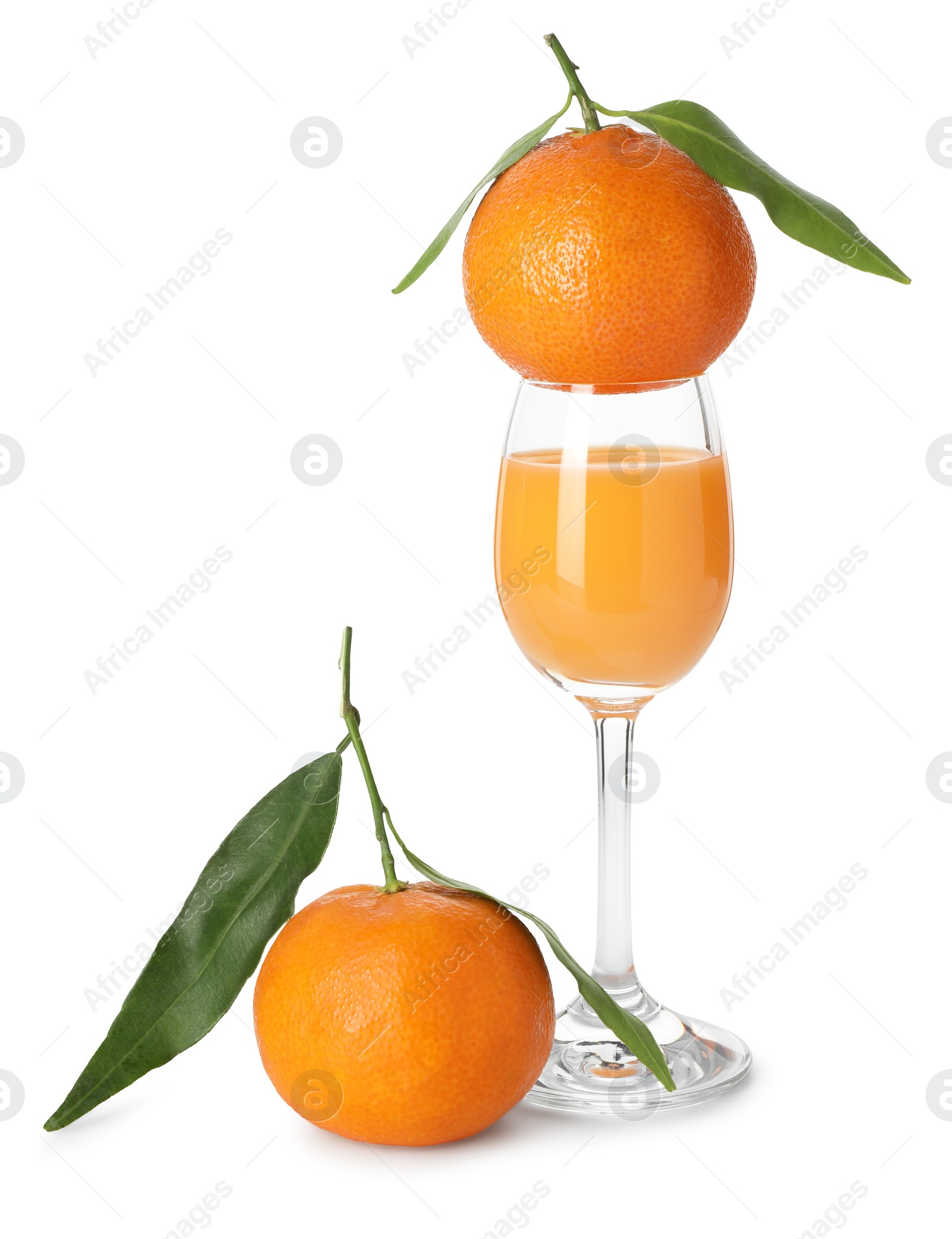 Photo of Tasty tangerine liqueur in glass and fresh fruits isolated on white