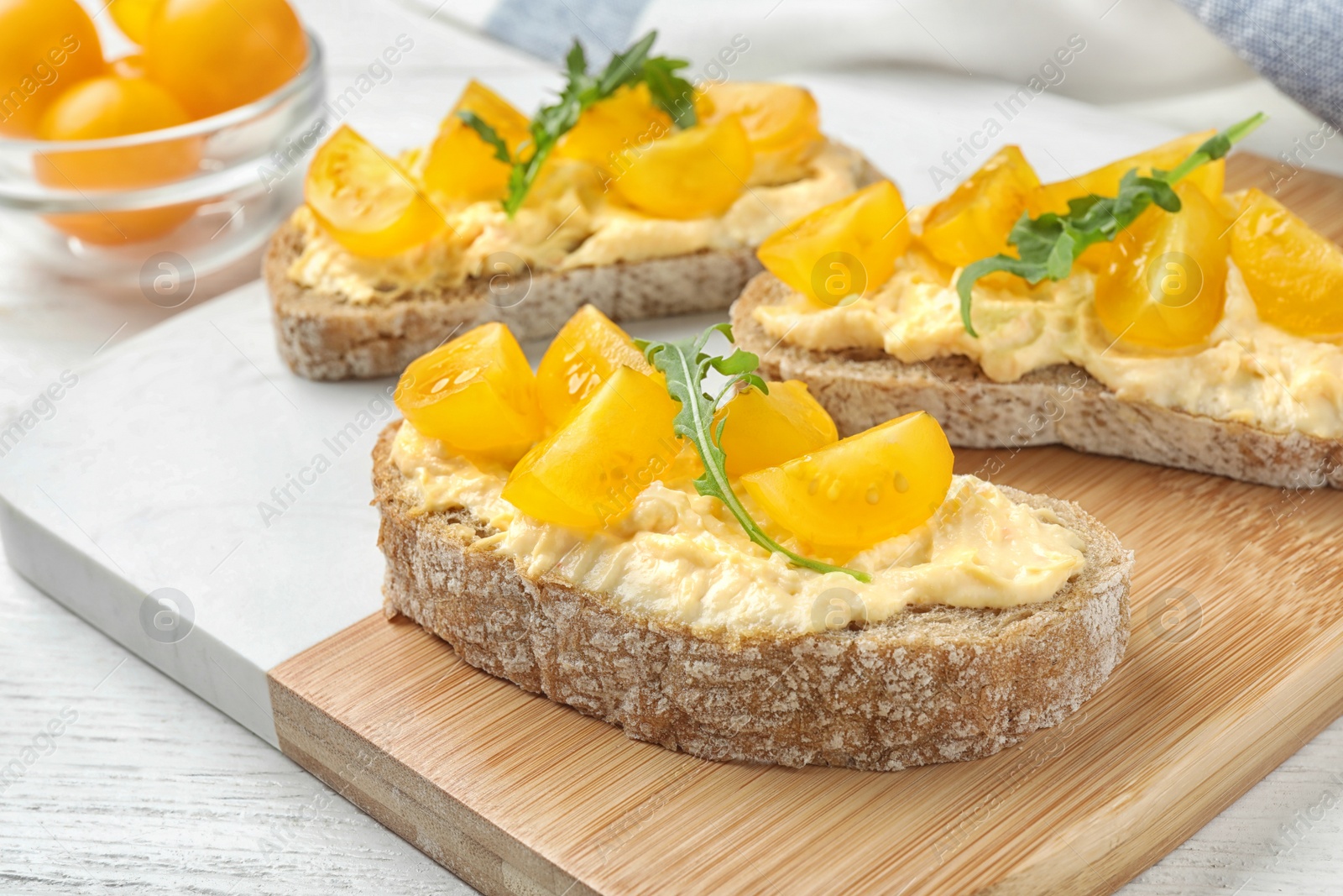 Photo of Tasty fresh tomato bruschettas served on board