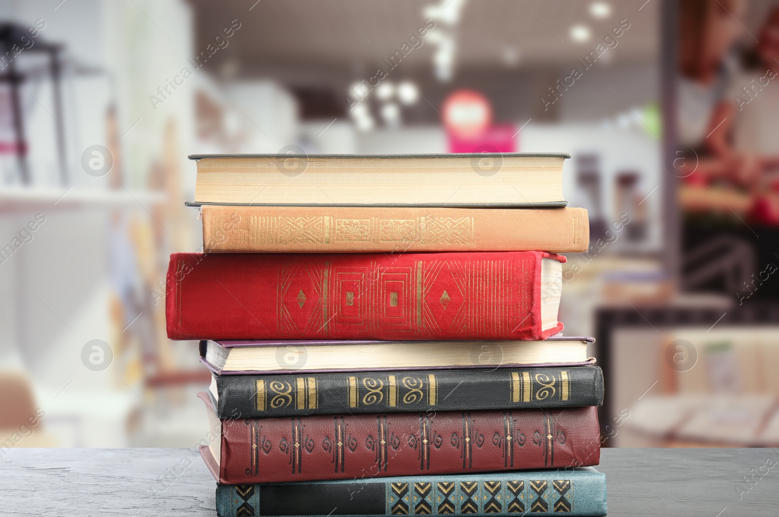Image of Collection of different books on table against blurred background