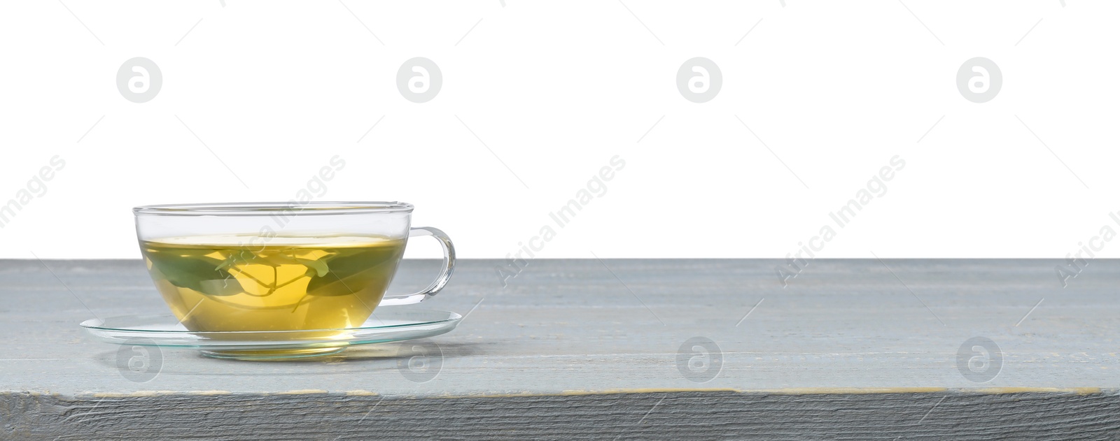 Photo of Refreshing green tea in cup on grey wooden table against white background