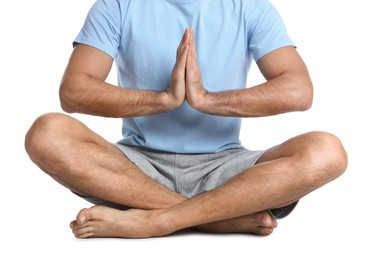 Man meditating on white background, closeup. Harmony and zen