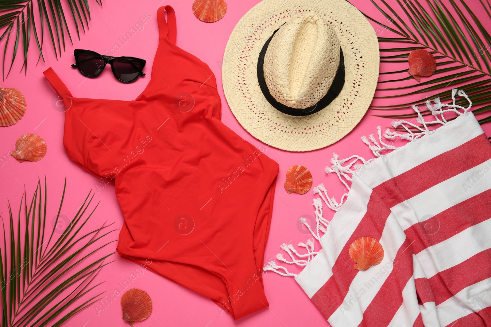 Photo of Flat lay composition with different beach objects on pink background