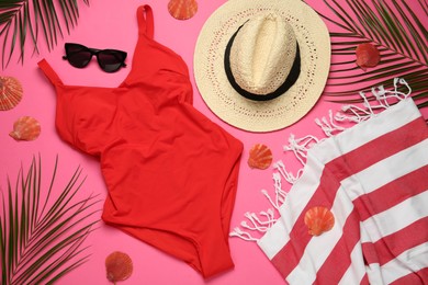 Flat lay composition with different beach objects on pink background