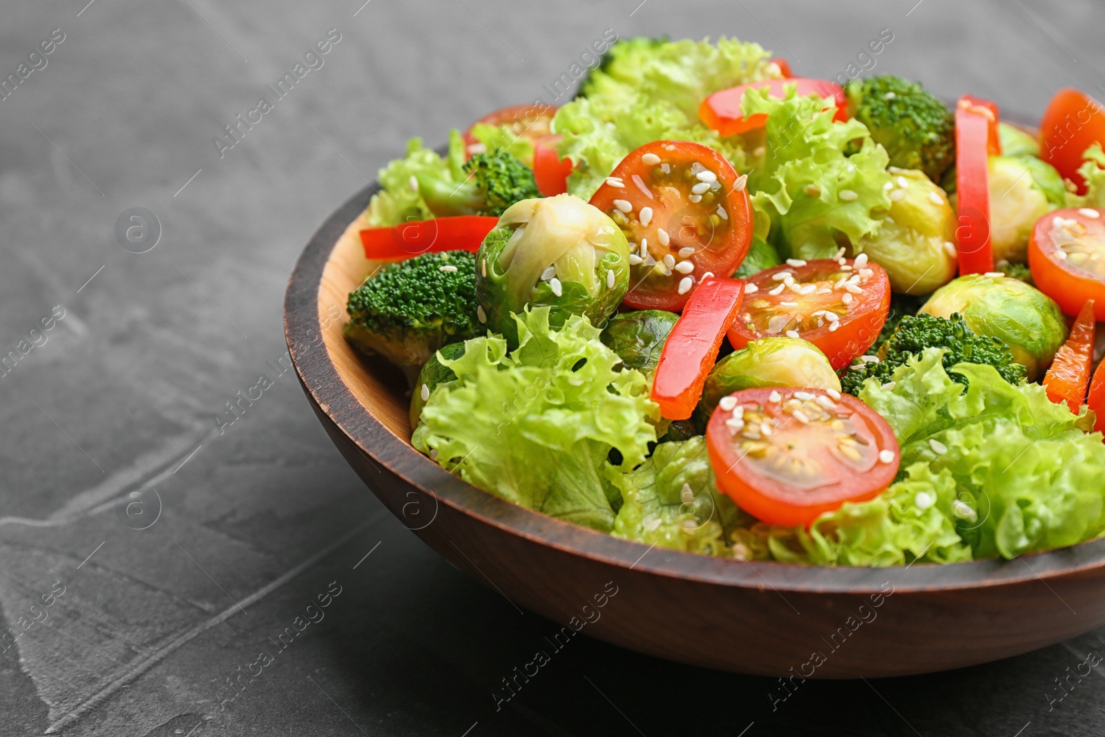 Photo of Tasty salad with Brussels sprouts on grey table, closeup
