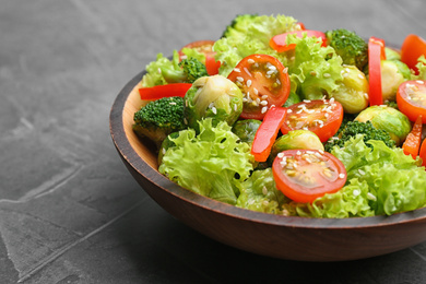 Tasty salad with Brussels sprouts on grey table, closeup