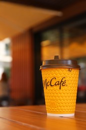 Photo of MYKOLAIV, UKRAINE - AUGUST 11, 2021: Hot McDonald's drink on table in cafe